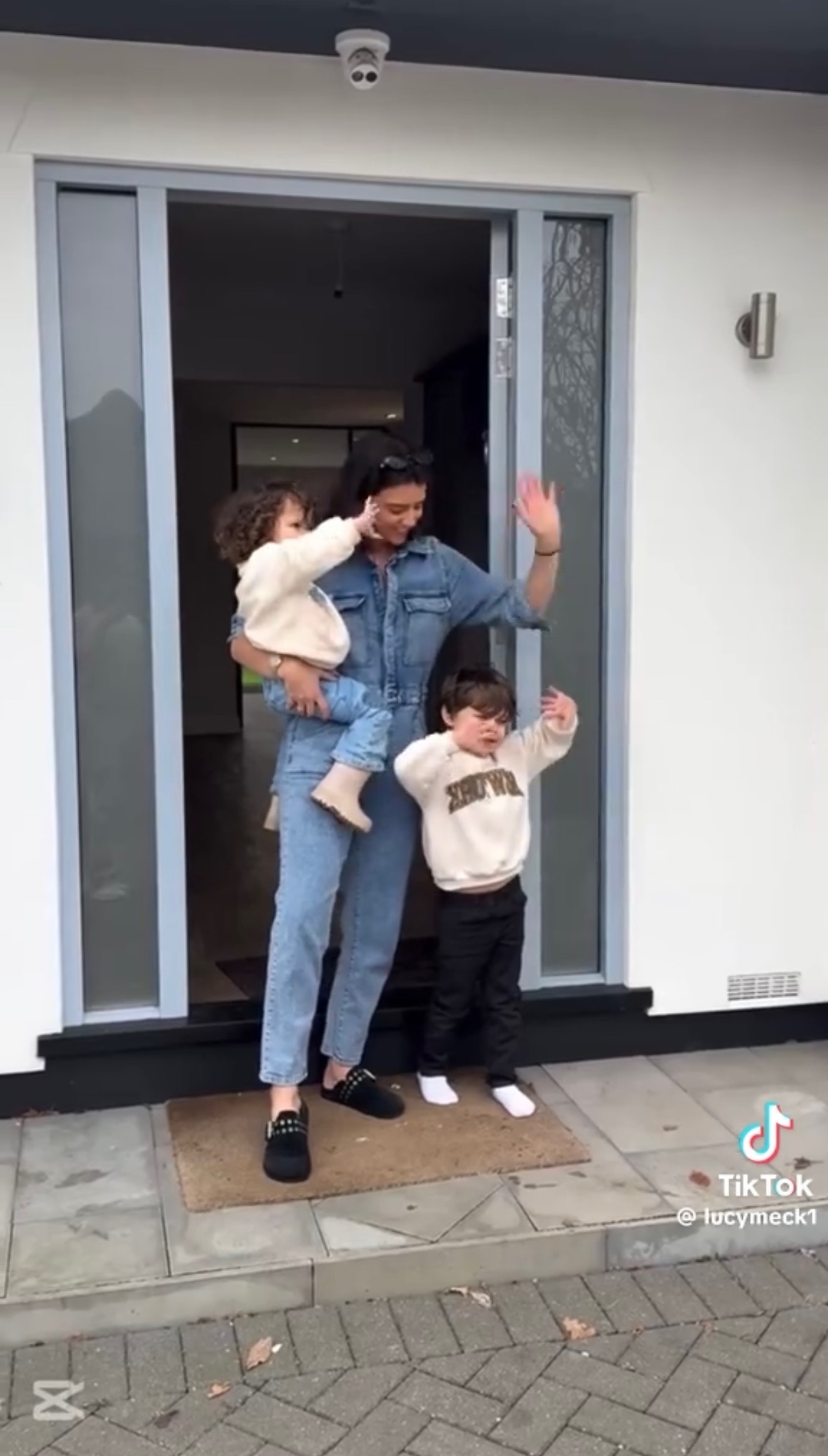 Lucy and her children waving