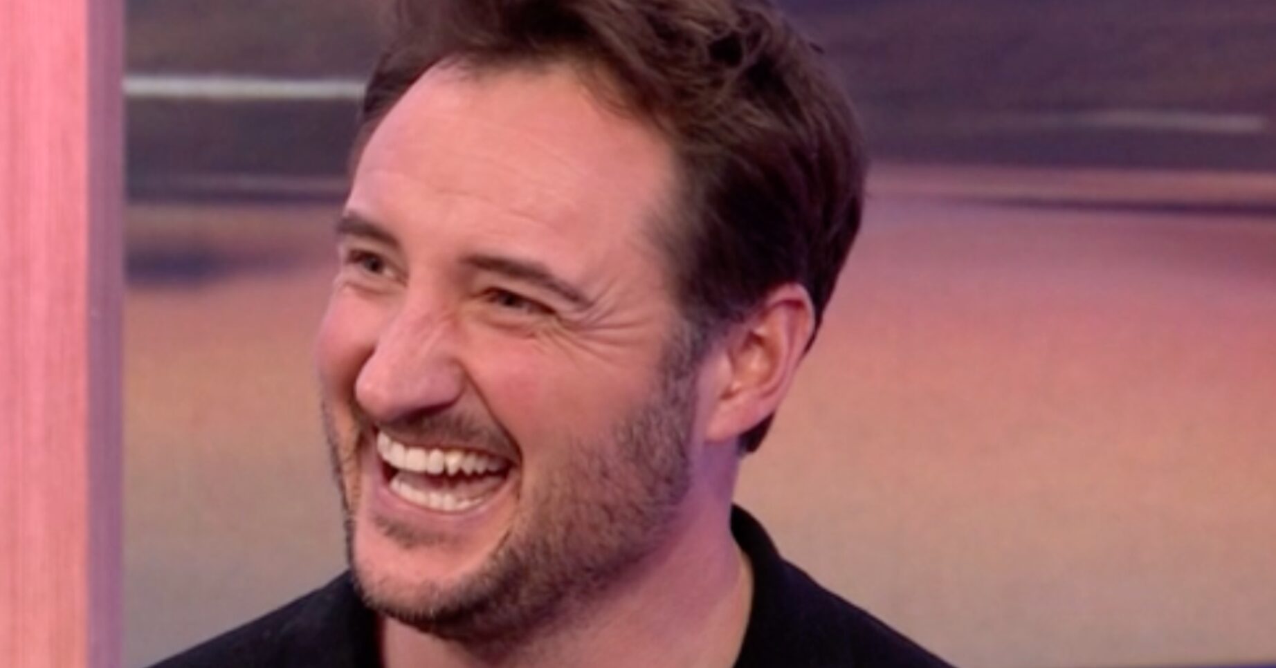 EastEnders' James Bye smiling