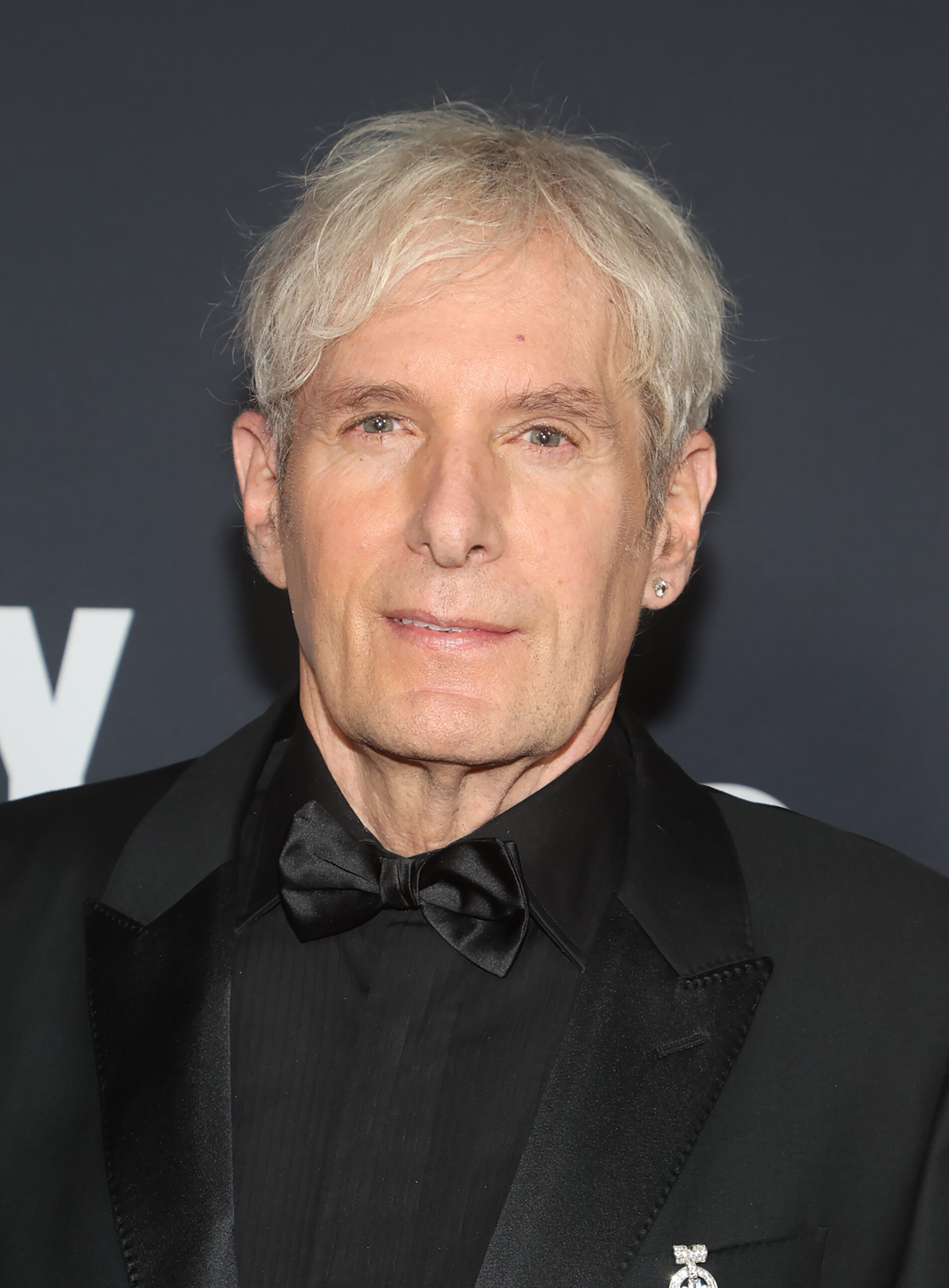 Michael Bolton wearing a black suit