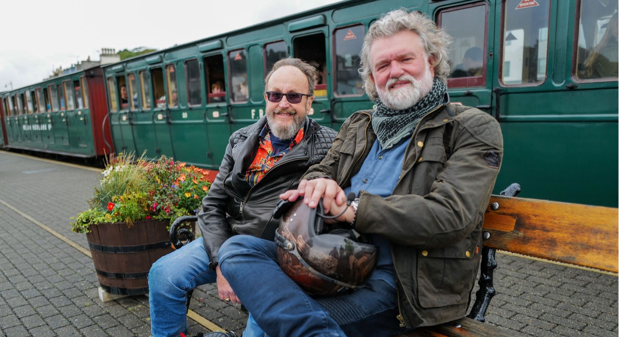 Dave Myers and Si King sat on a bench together