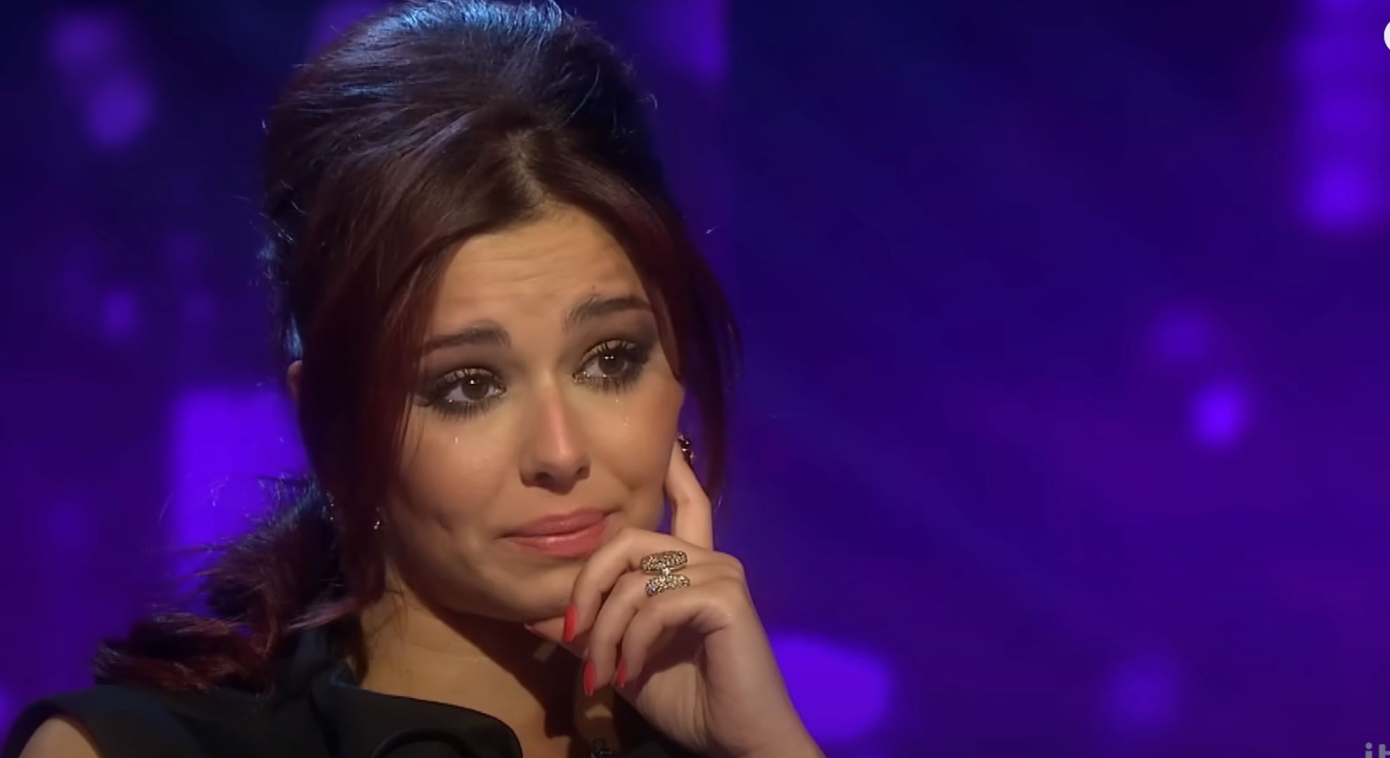 Cheryl appears tearful as she wears a black dress