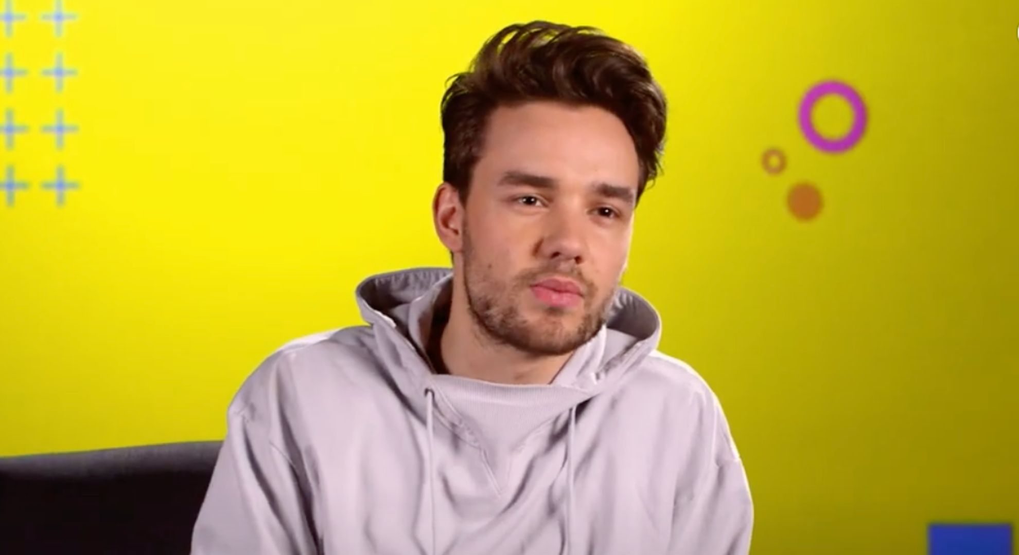 Liam Payne wears a beige jumper