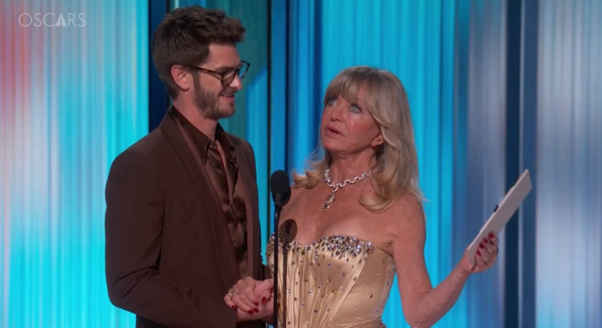 Andrew Garfield clasps the hand of Goldie Hawn