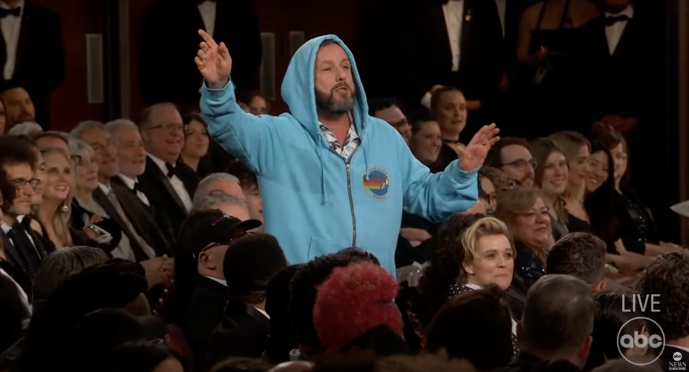 Adam Sandler in hoodie and shorts during Oscars