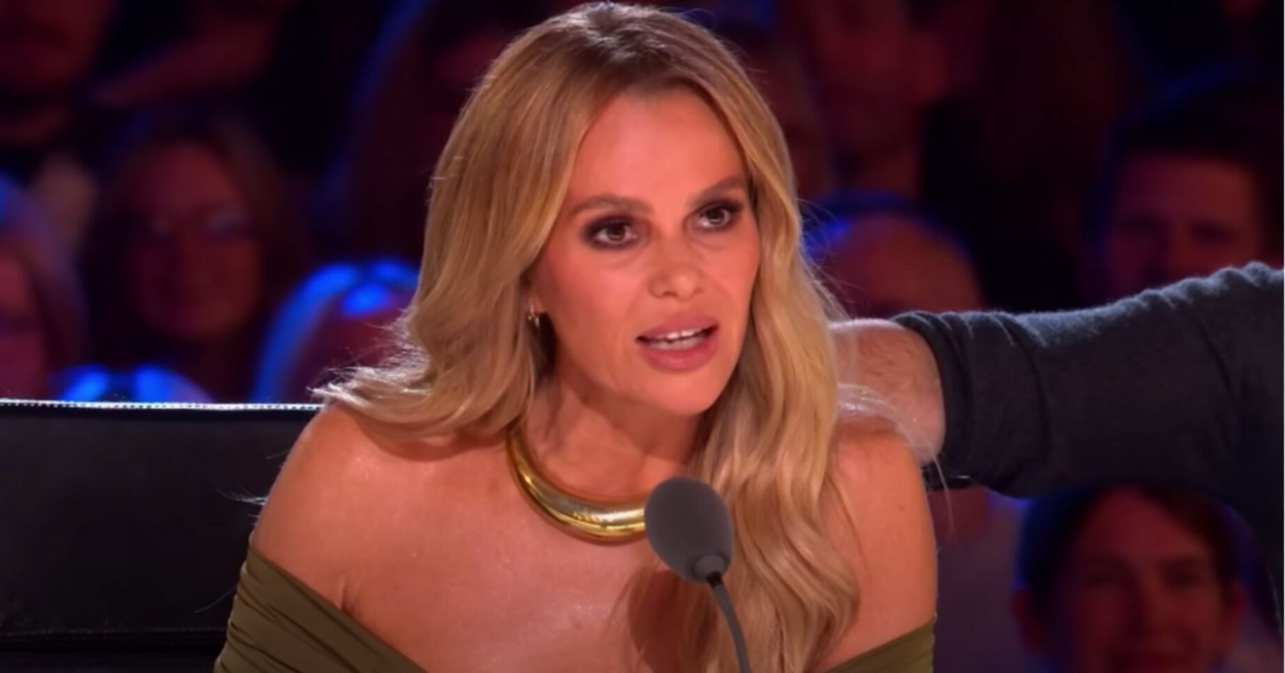Amanda Holden speaks into a microphone