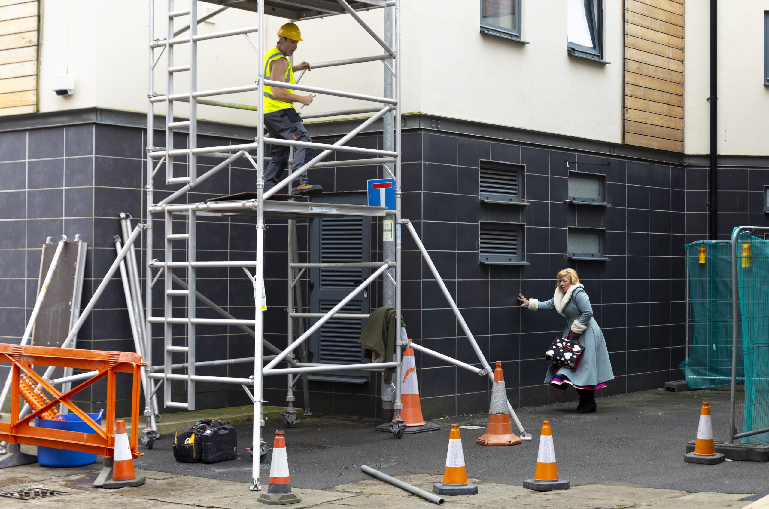 Julie walking near the scaffolding