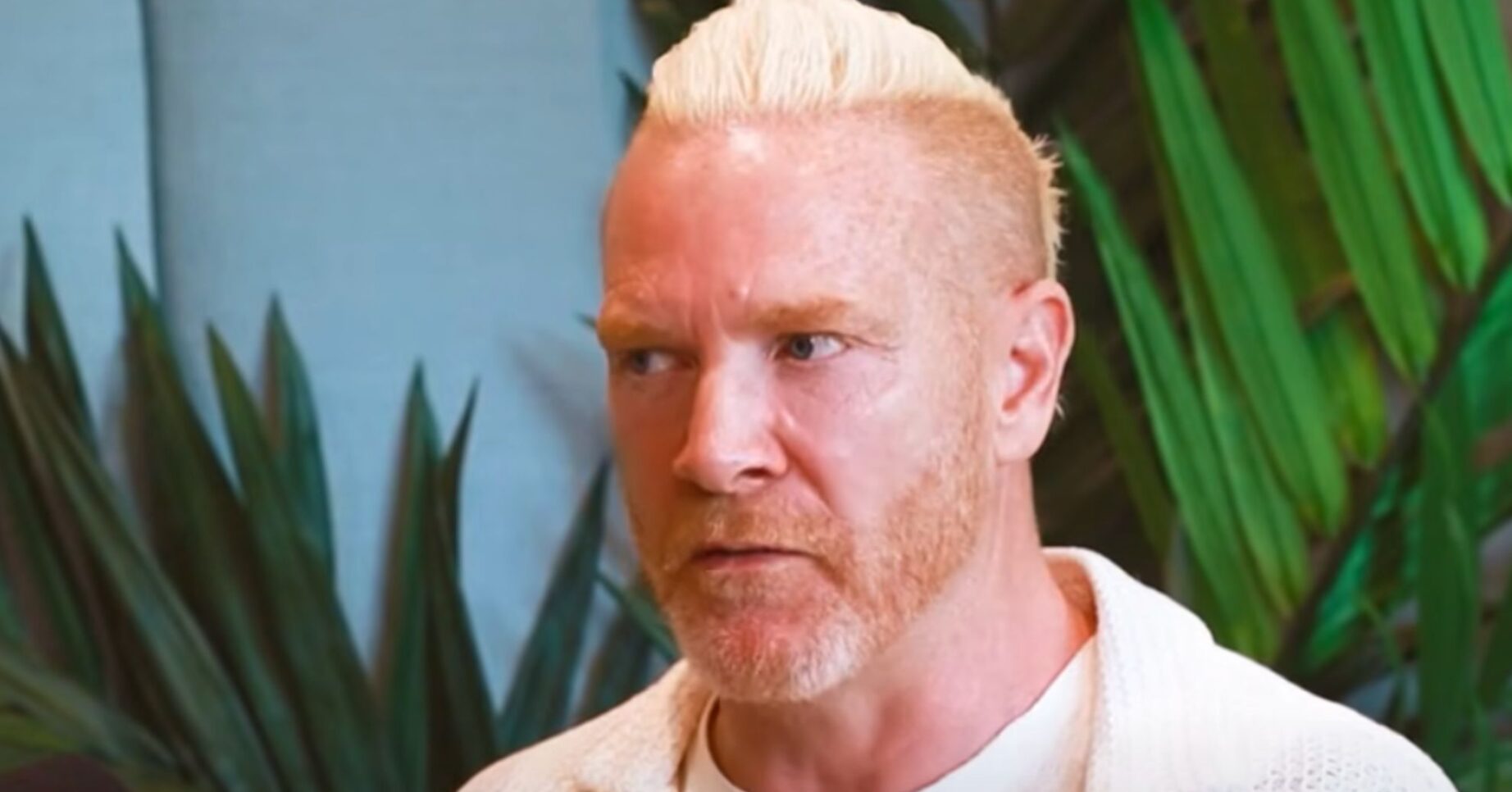 Iwan Thomas wears a white shirt and t-shirt