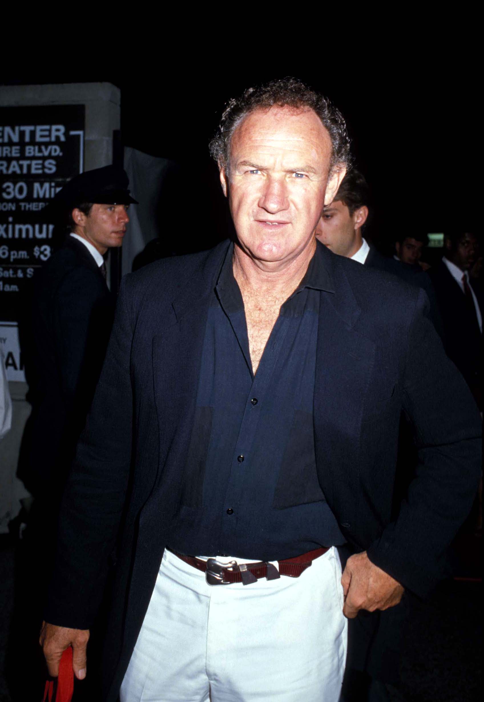 Gene Hackman wears a black shirt and blazer
