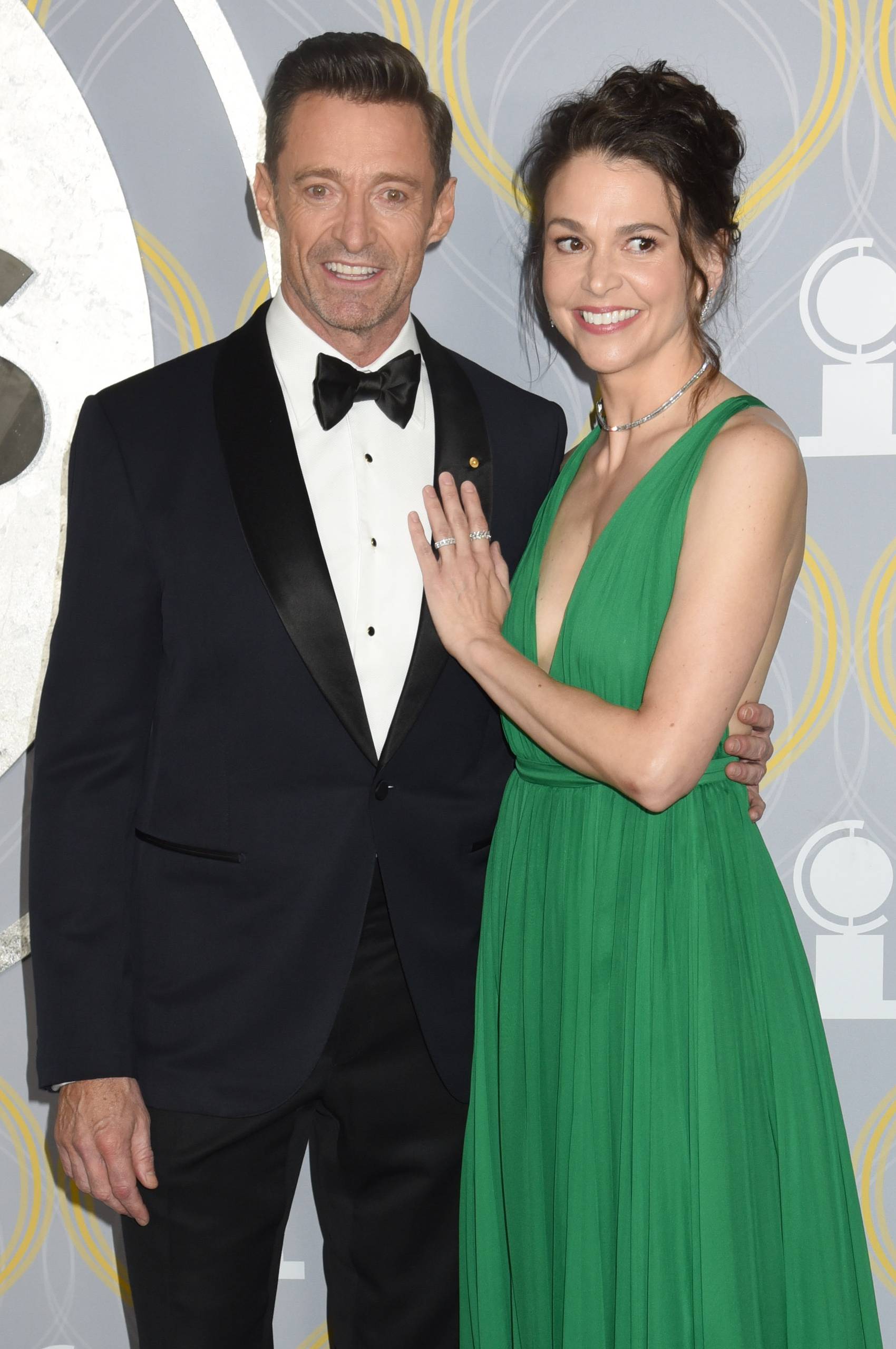 Hugh Jackman puts an arm around Sutton Foster