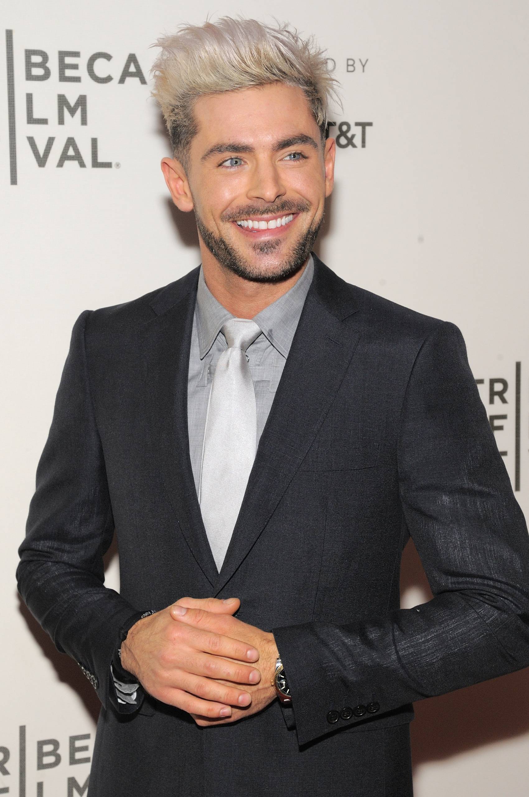 Zac Efron poses on a red carpet in 2019