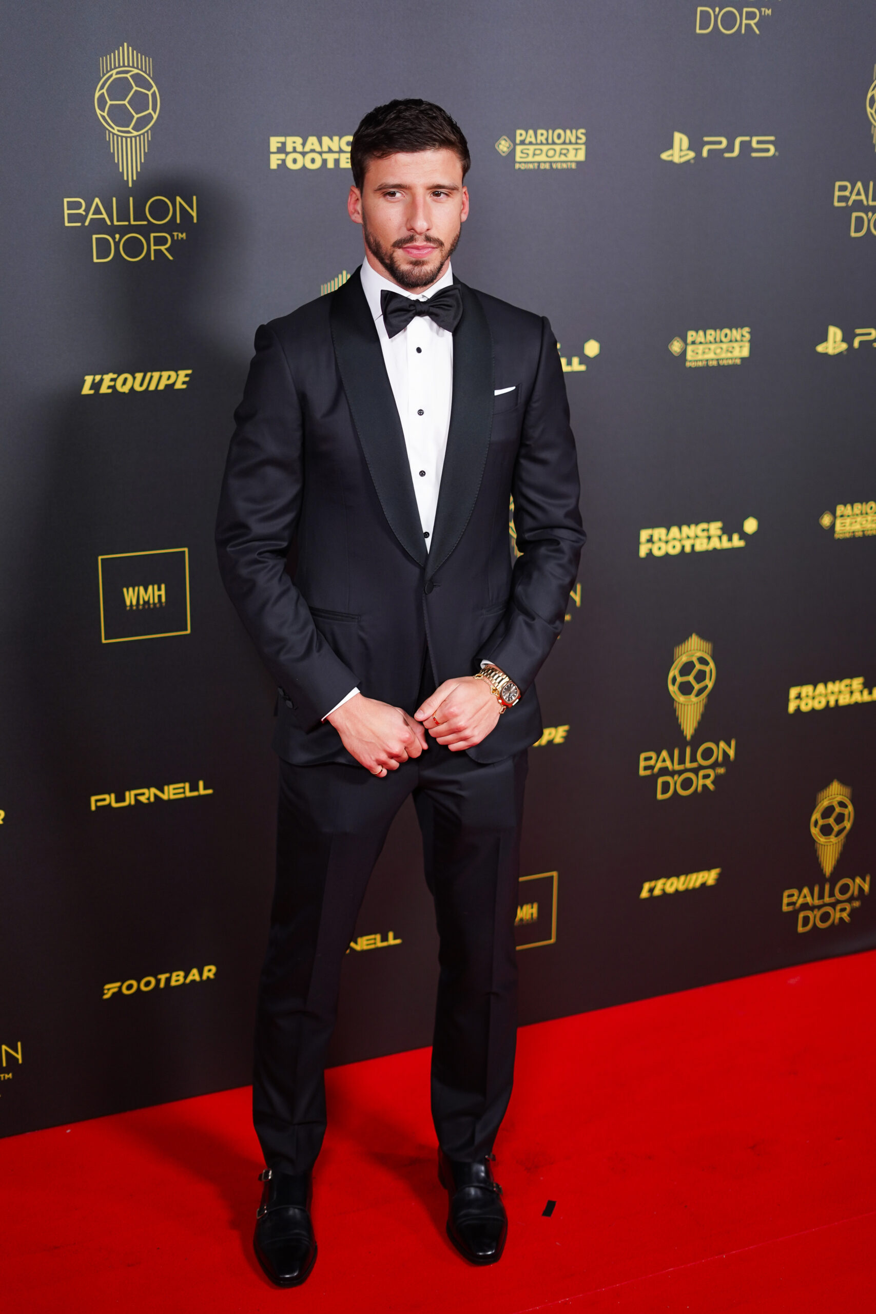 Ruben Dias wears a black and white tuxedo suit