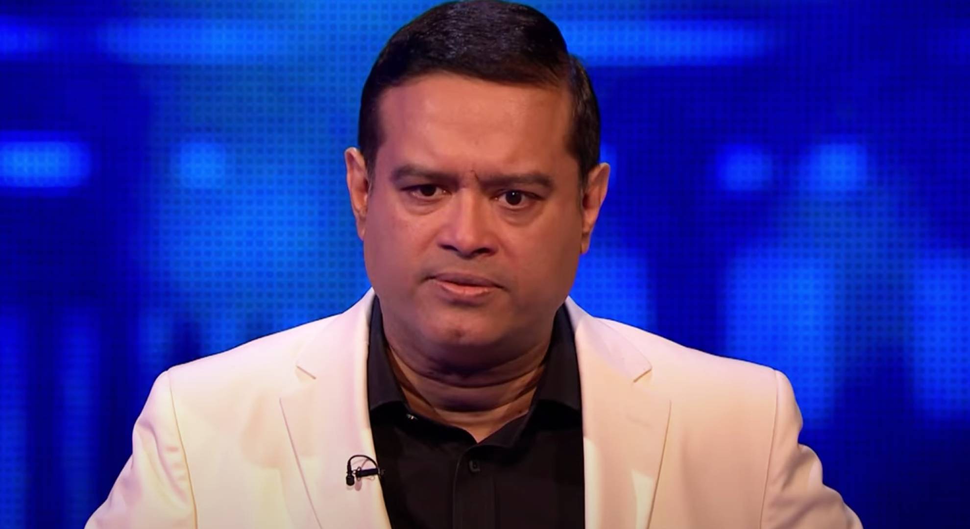 Paul Sinha listens to a question