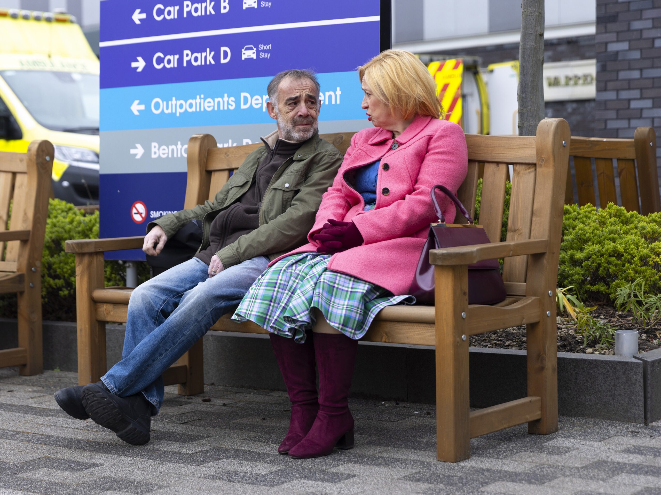 Coronation Street's Kevin and Julie sit on a bench