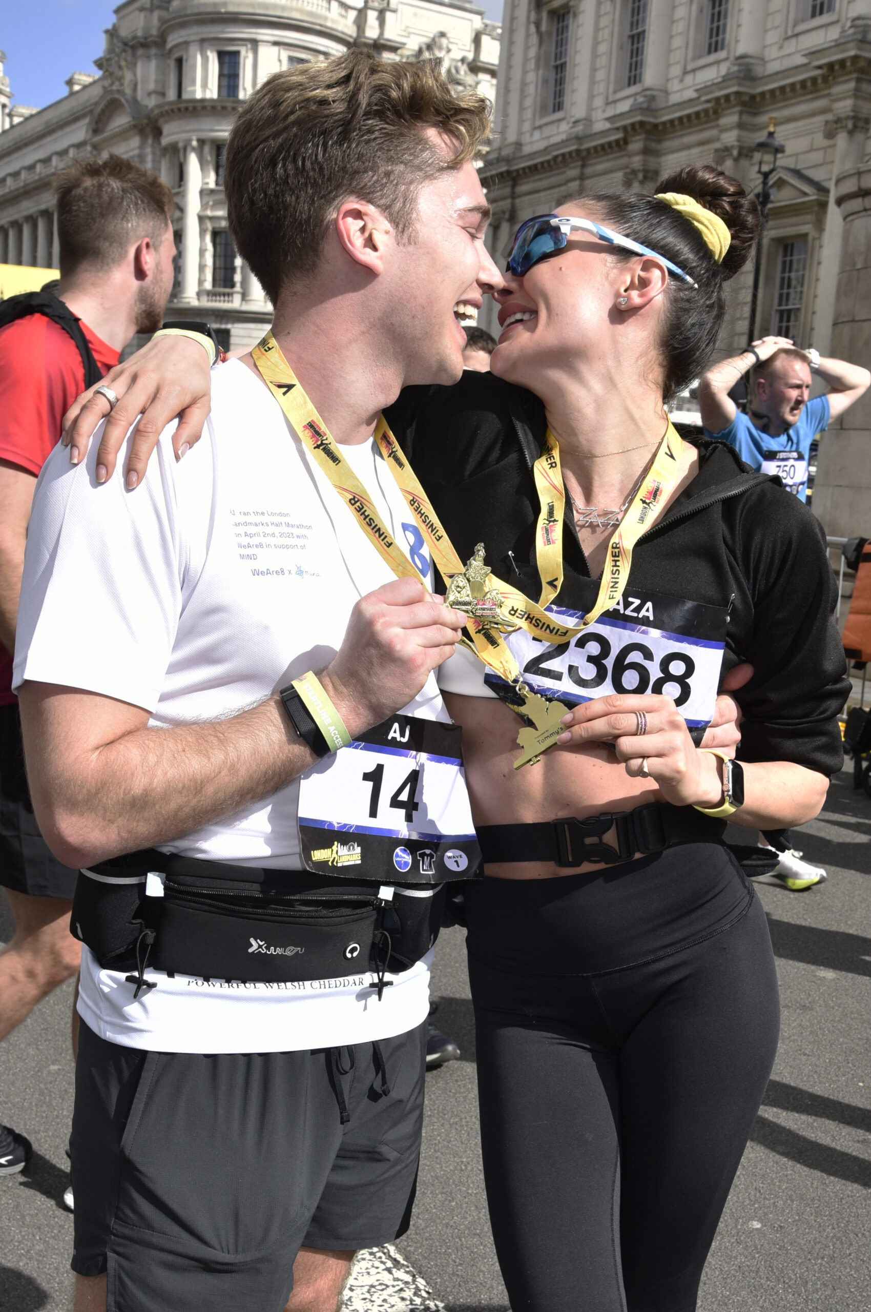 AJ Pritchard and Zara going in for a kiss after a marathon