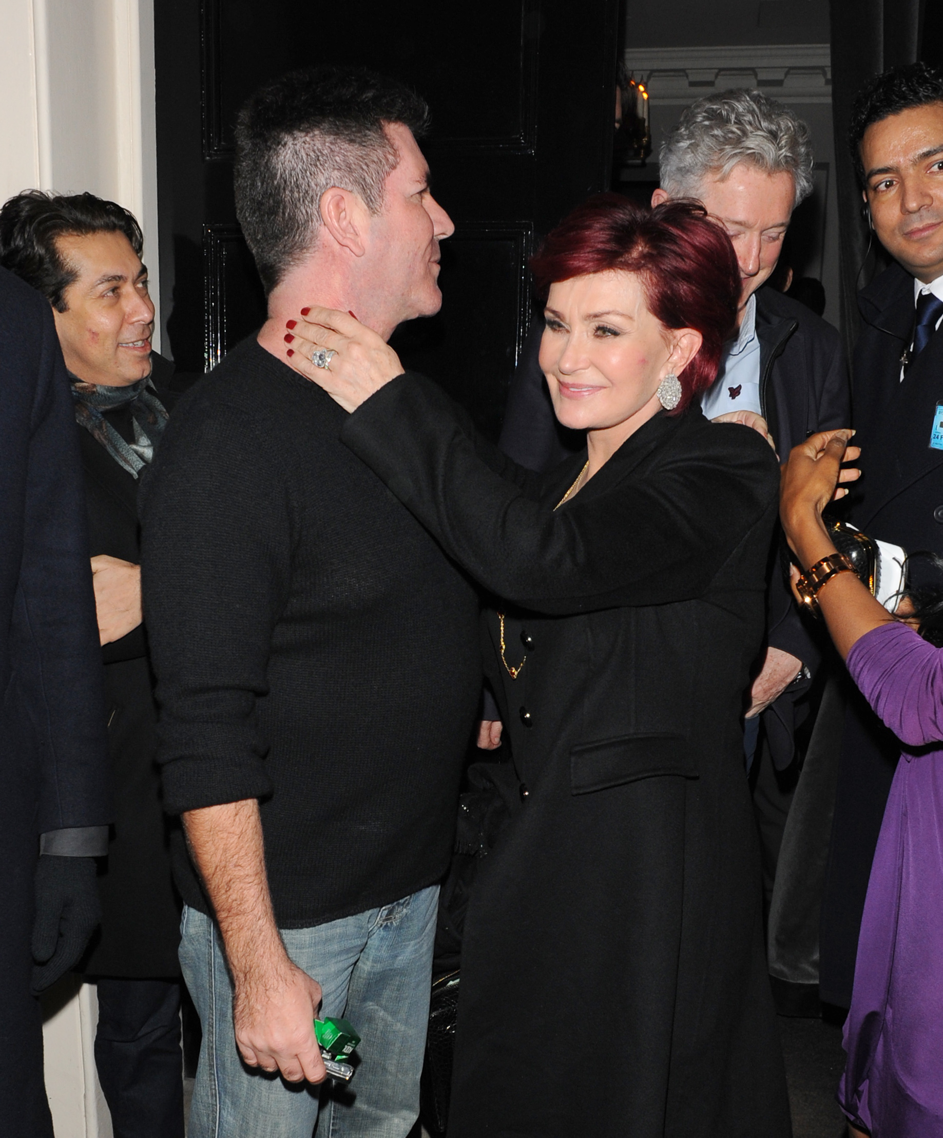 Sharon Osbourne holding Simon Cowell neck