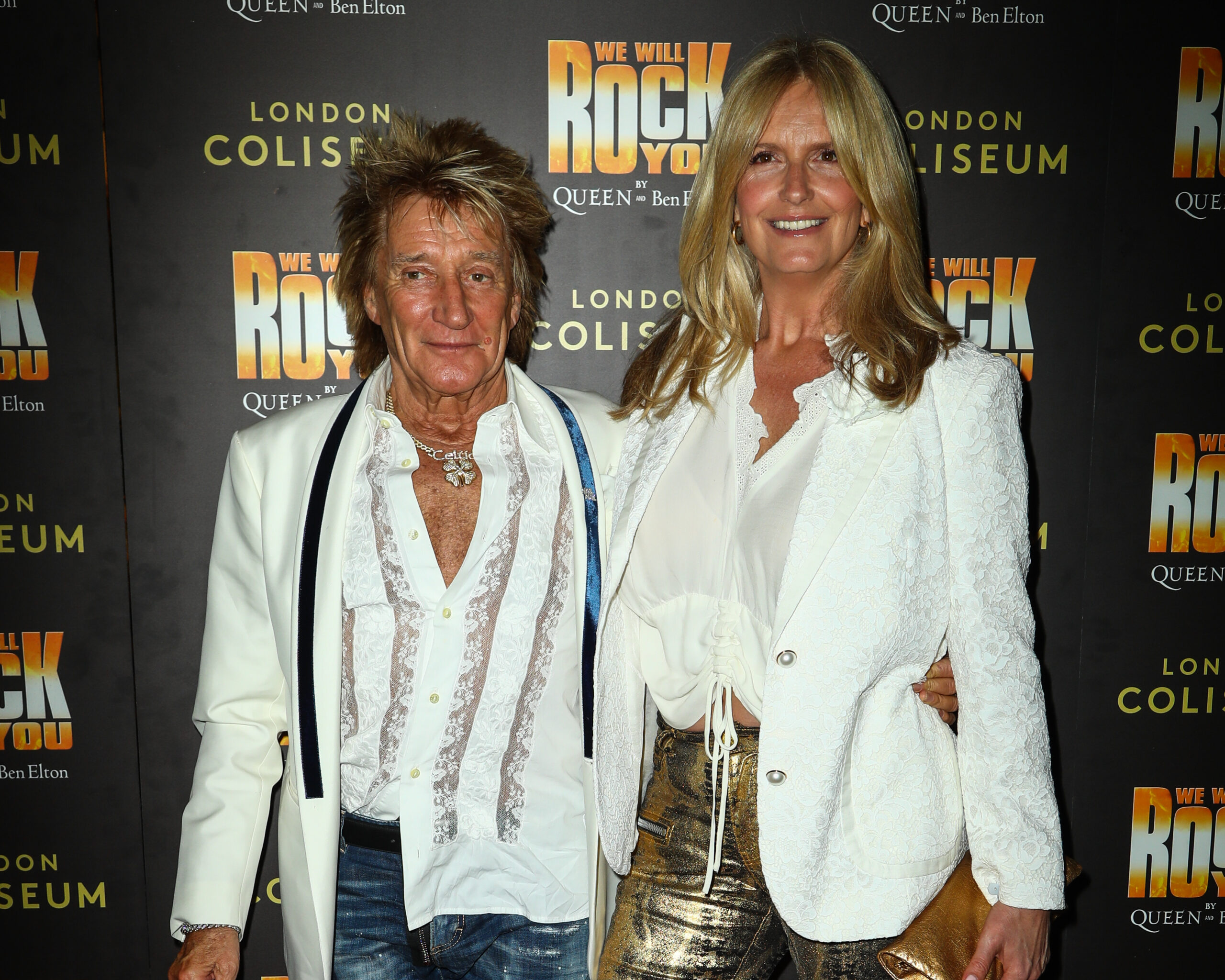 Rod Stewart and Penny Lancaster smiling on a night out wearing white