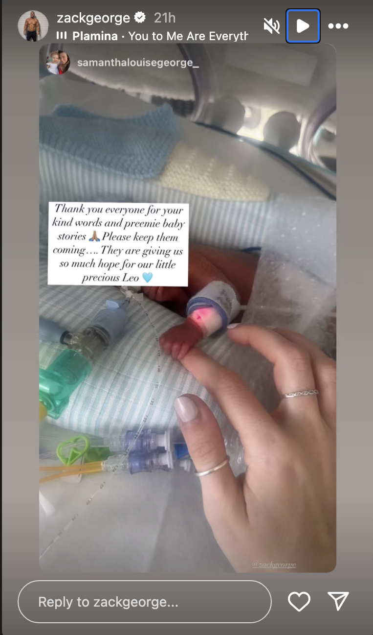 Zack's wife holding her baby's hand 