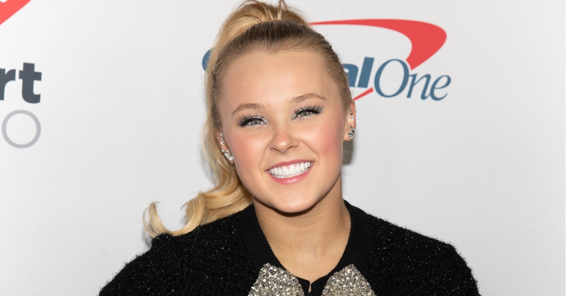 JoJo Siwa smiling on carpet