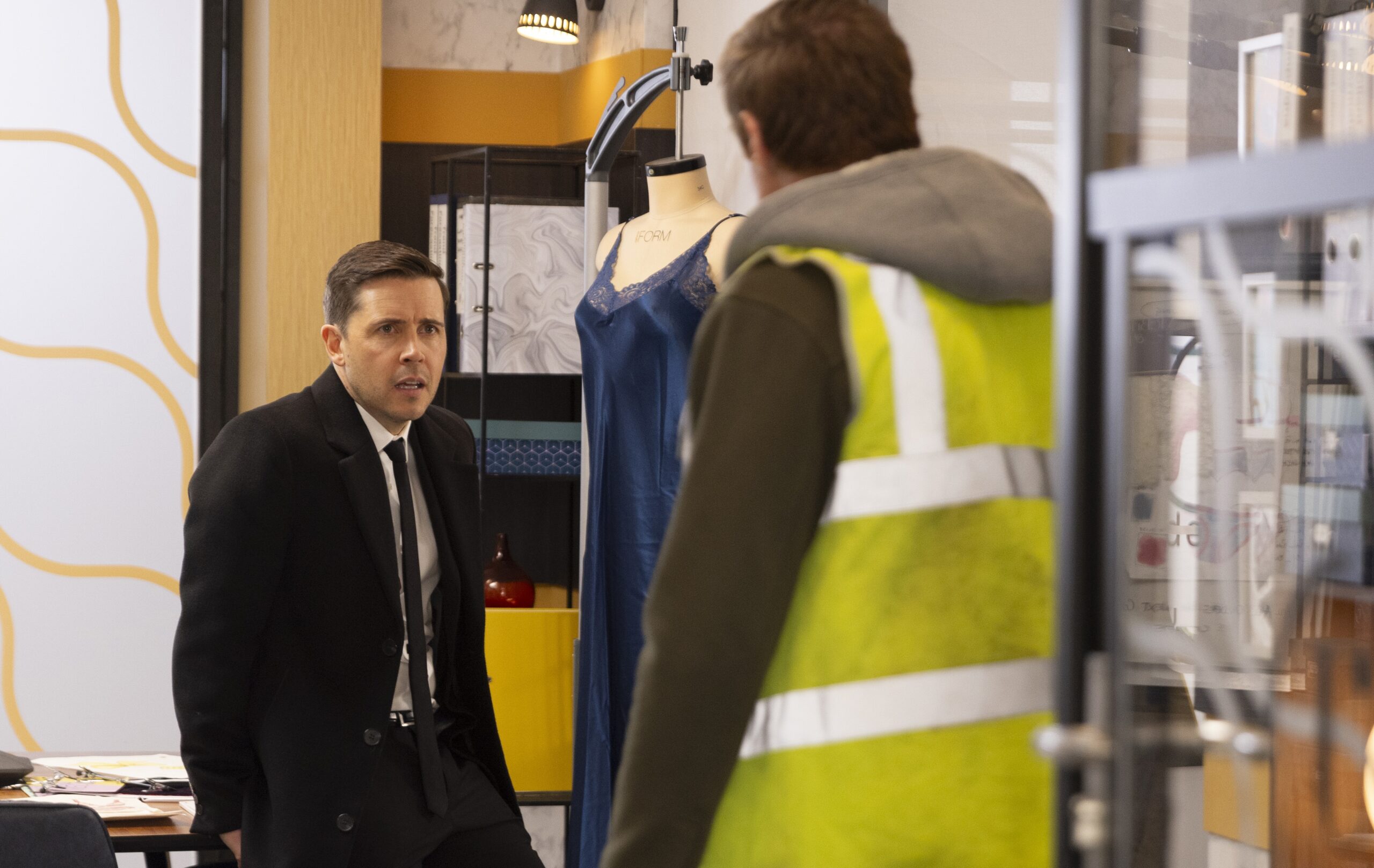 Todd looks worried as Theo talks to him on Corrie
