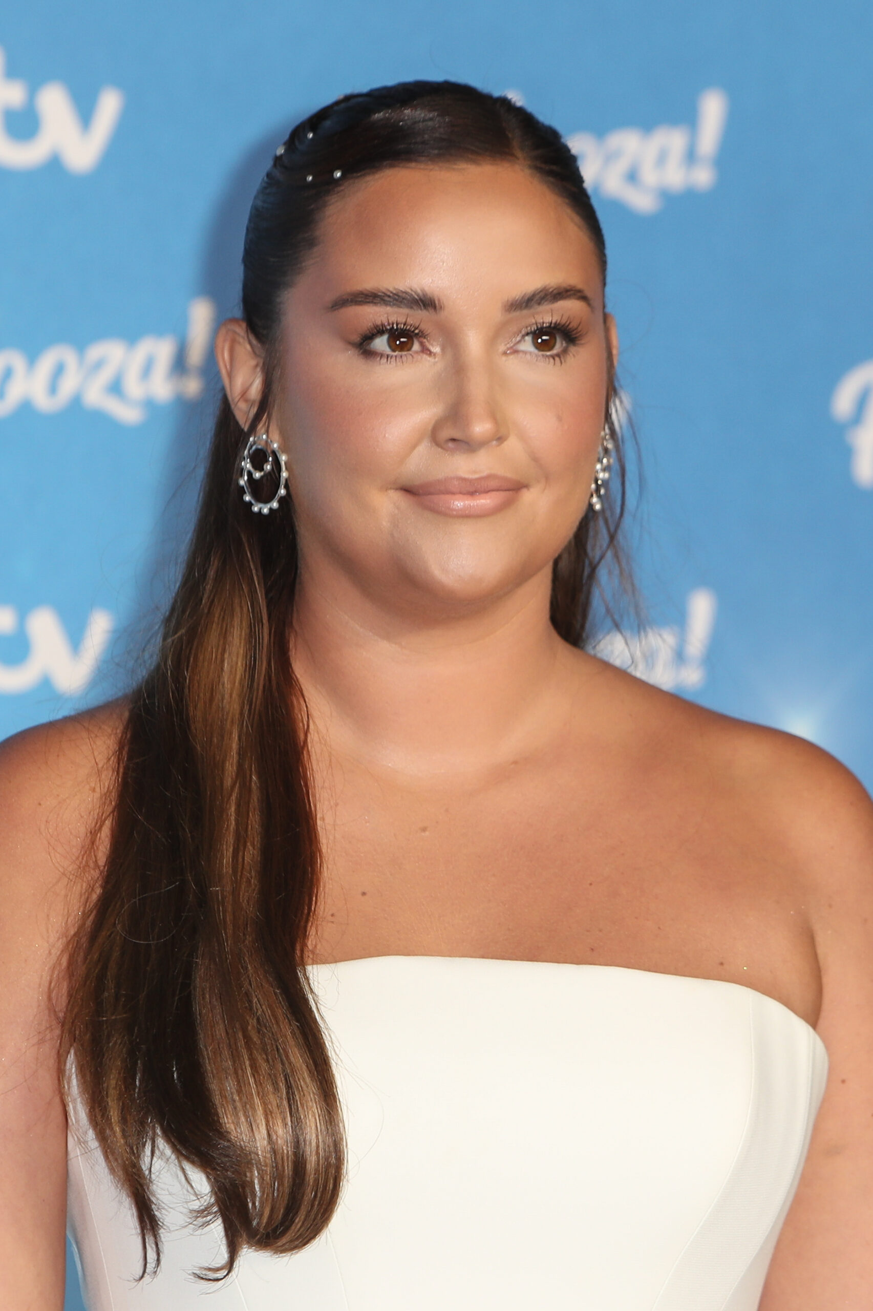 Jacqueline Jossa wearing white, smiling slightly