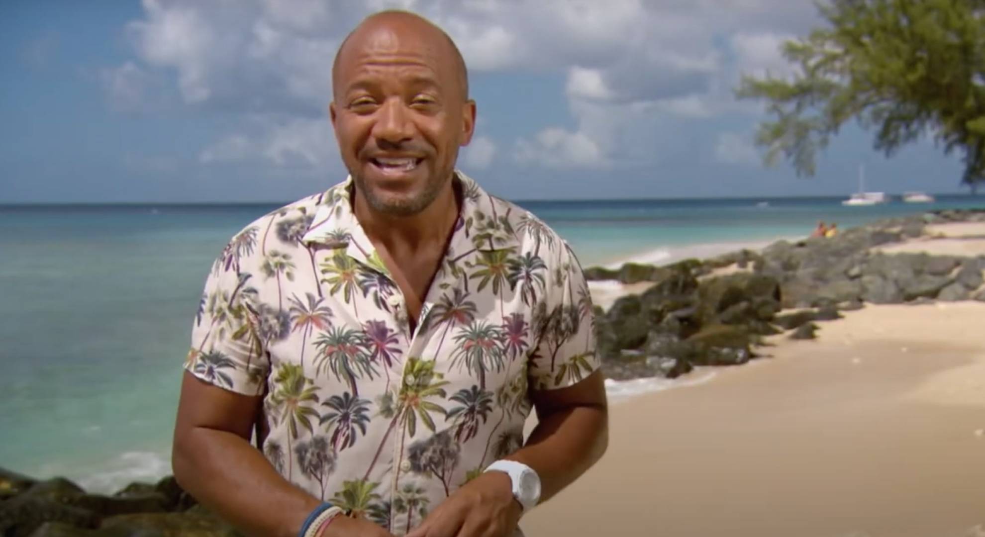 Craig Rowe smiles as he speaks to camera