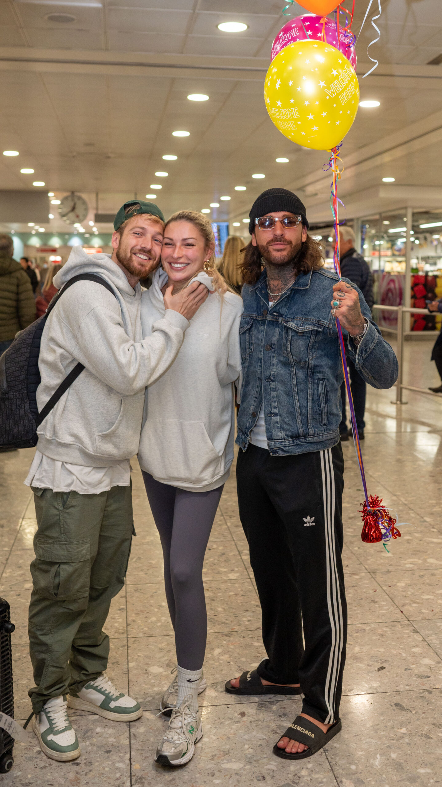 Sam Thompson, Zara McDermott and Pete Wicks at the airport with balloons