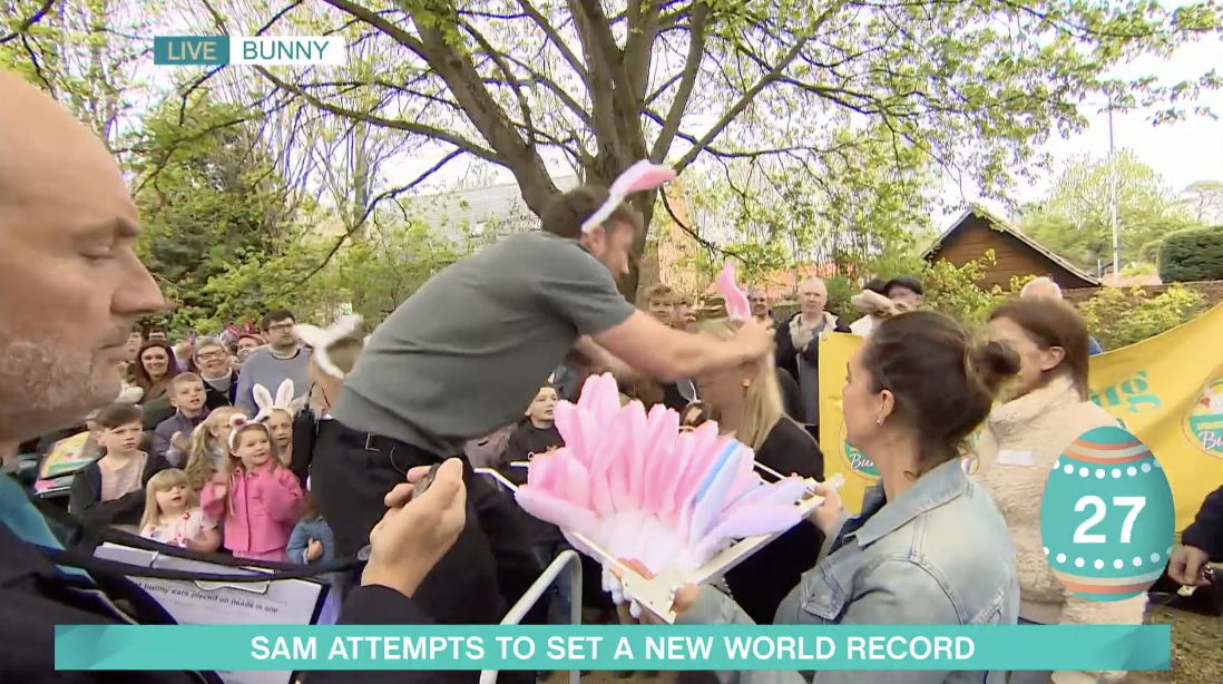 Sam Thompson putting bunny ears on people's heads