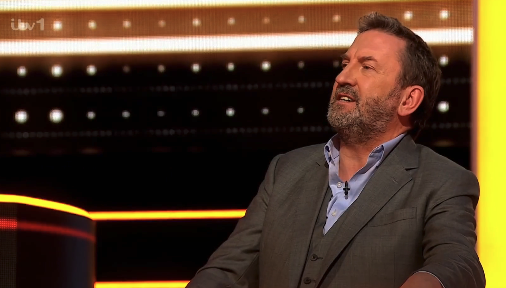 Lee Mack speaking to a contestant on The 1% Club