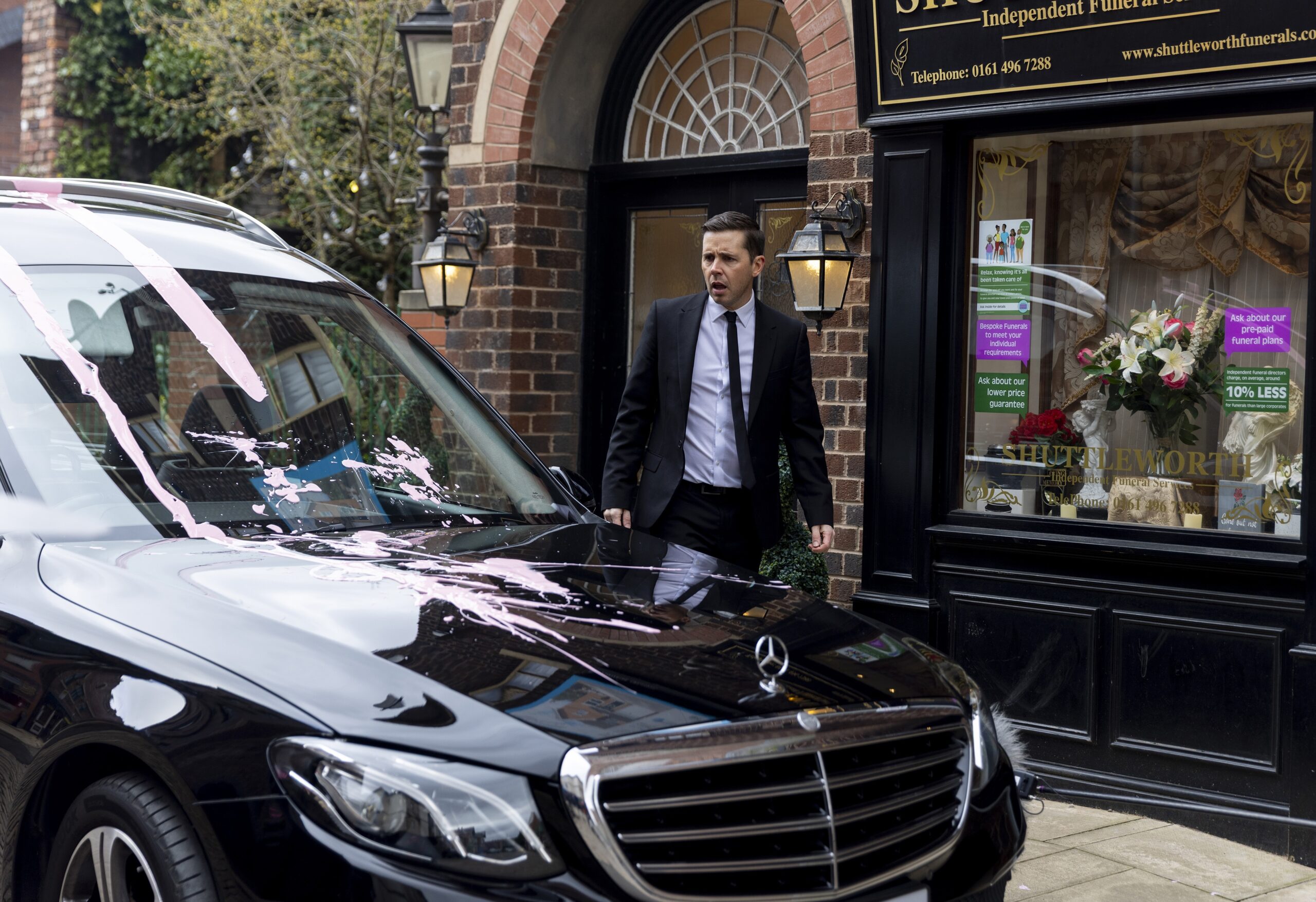 Todd staring at paint splatted hearse in Corrie