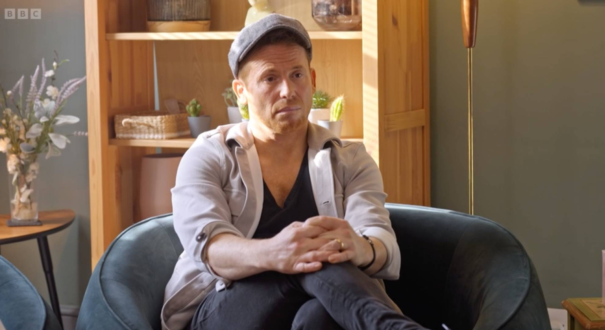 Joe Swash crosses his legs