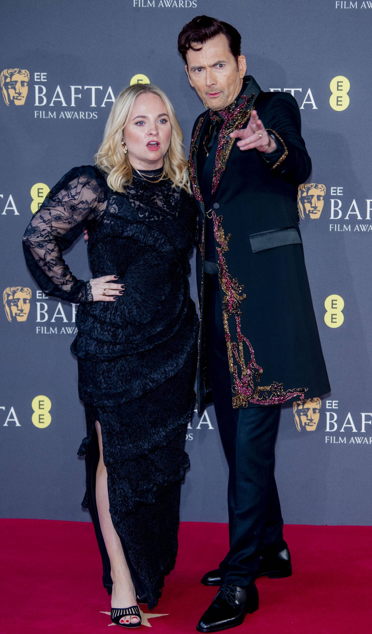 David Tennant points alongside his wife