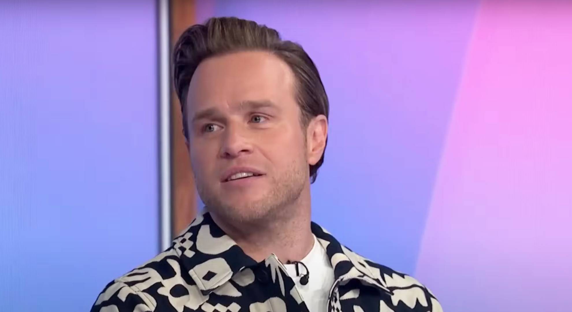 Olly Murs turns to his side