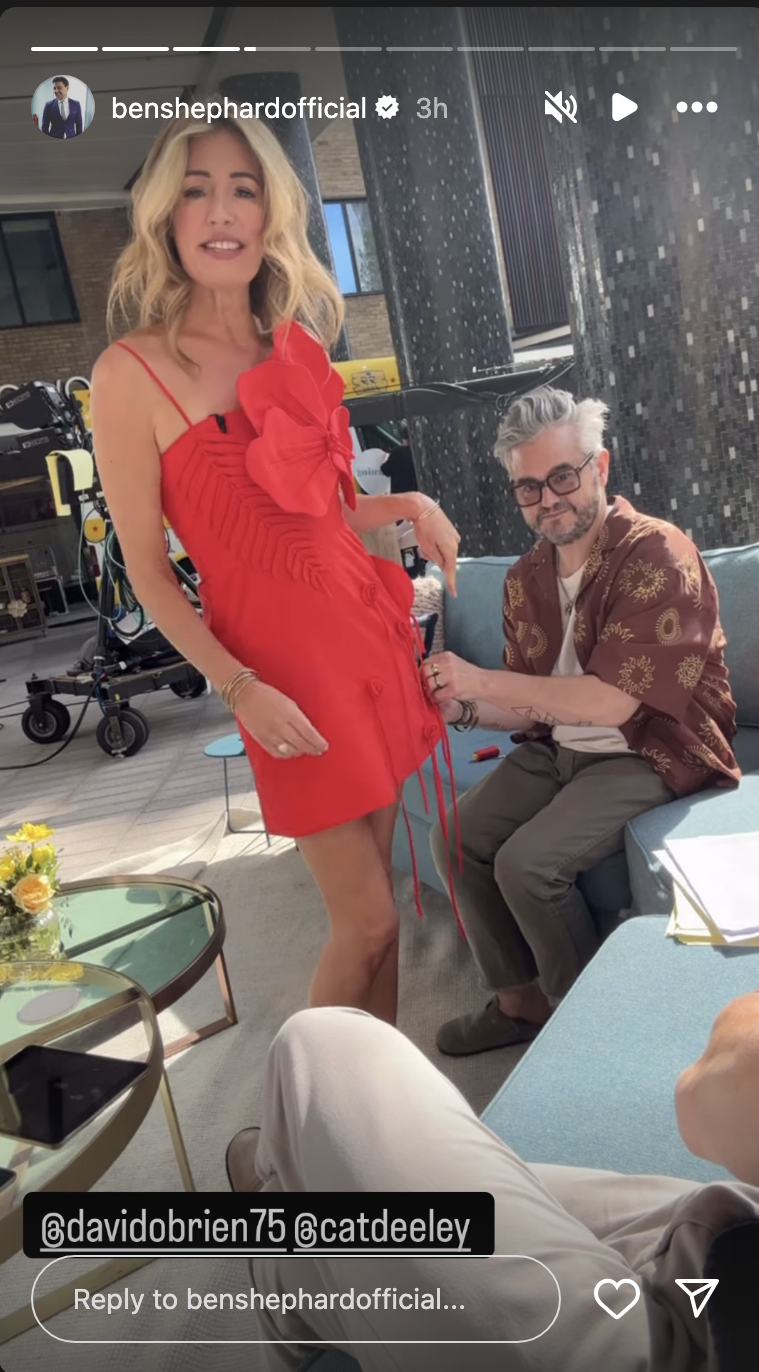 Cat Deeley in a red dress having her dress stitched 