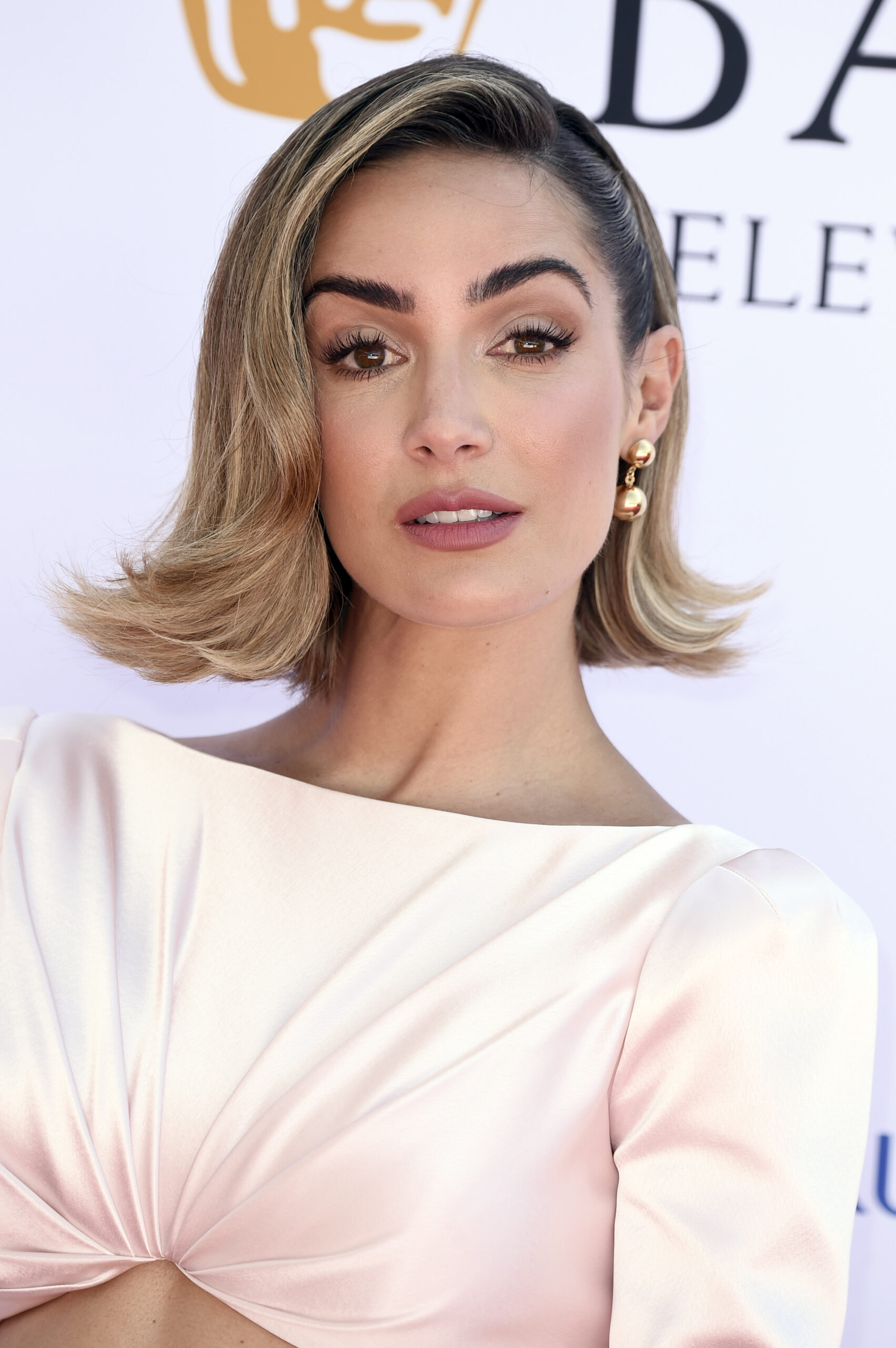 Frankie Bridge posing in a white dress 