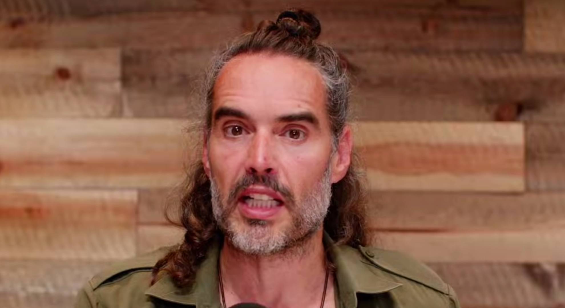 Russell Brand faces the camera