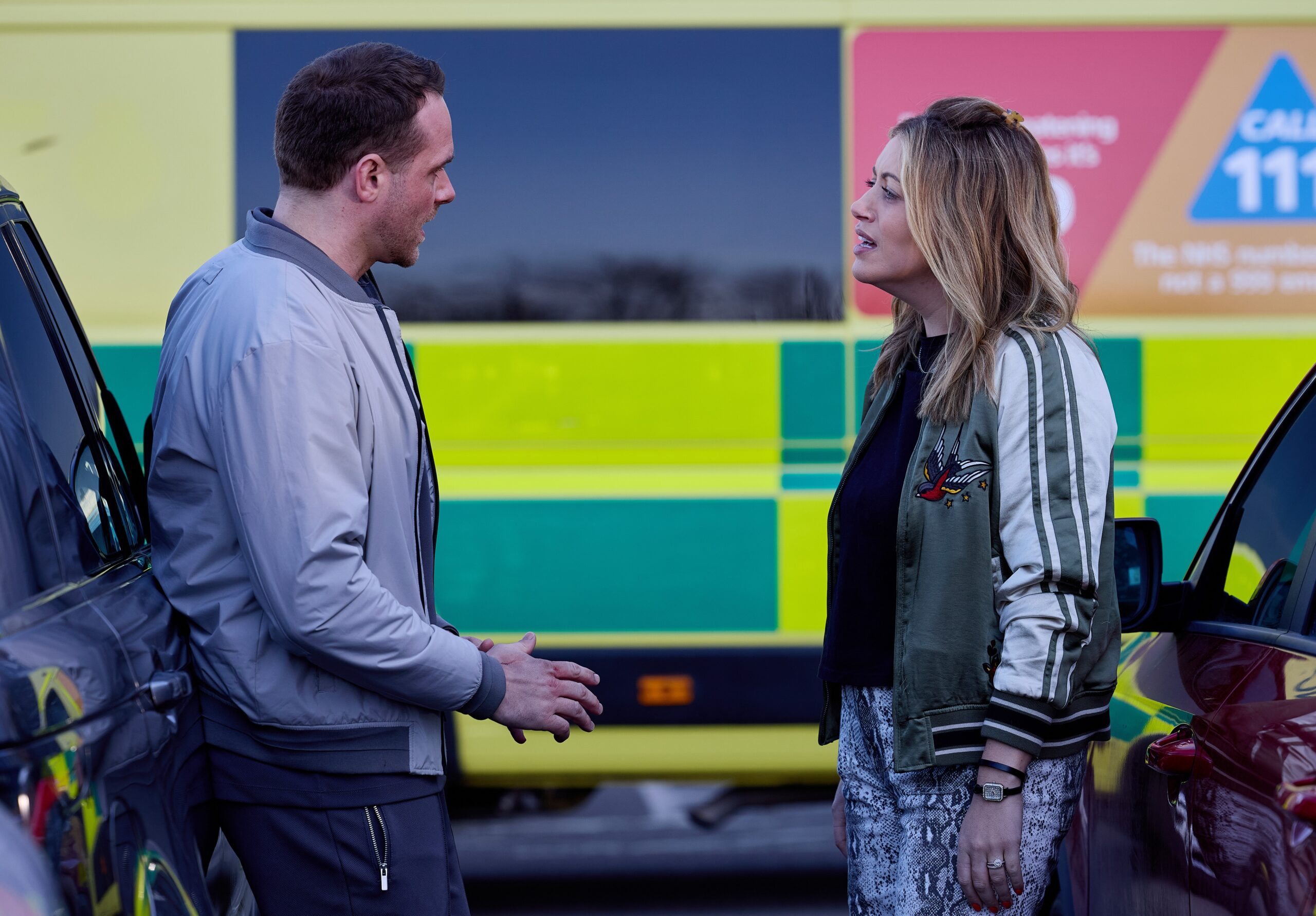 Mick and Lou arguing outside ambulance