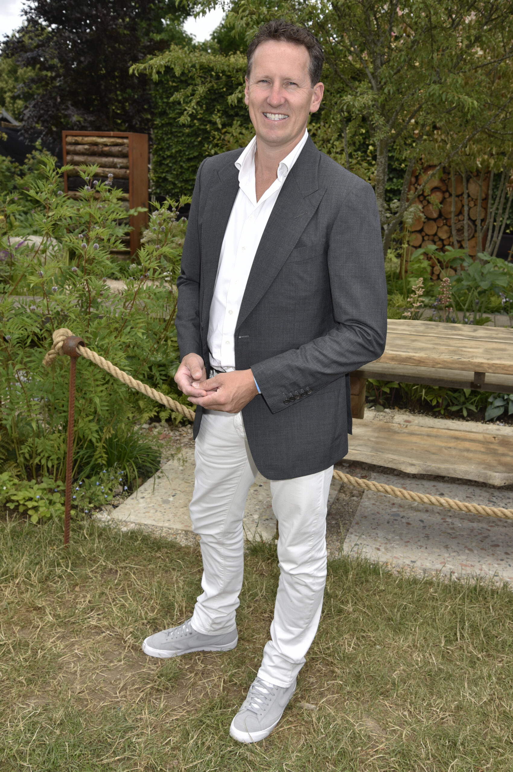 Brendan Cole smiling in suit at event