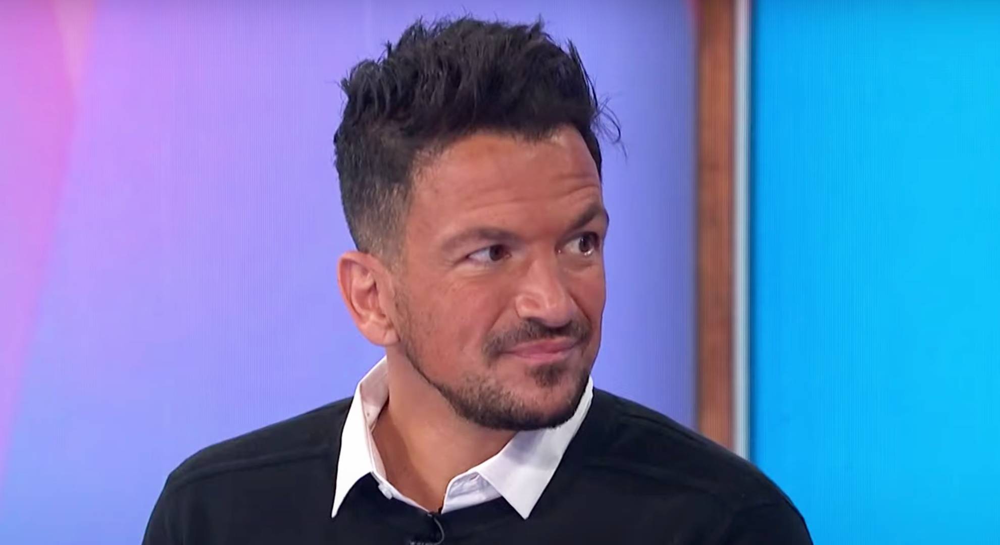 Peter Andre looks to his side