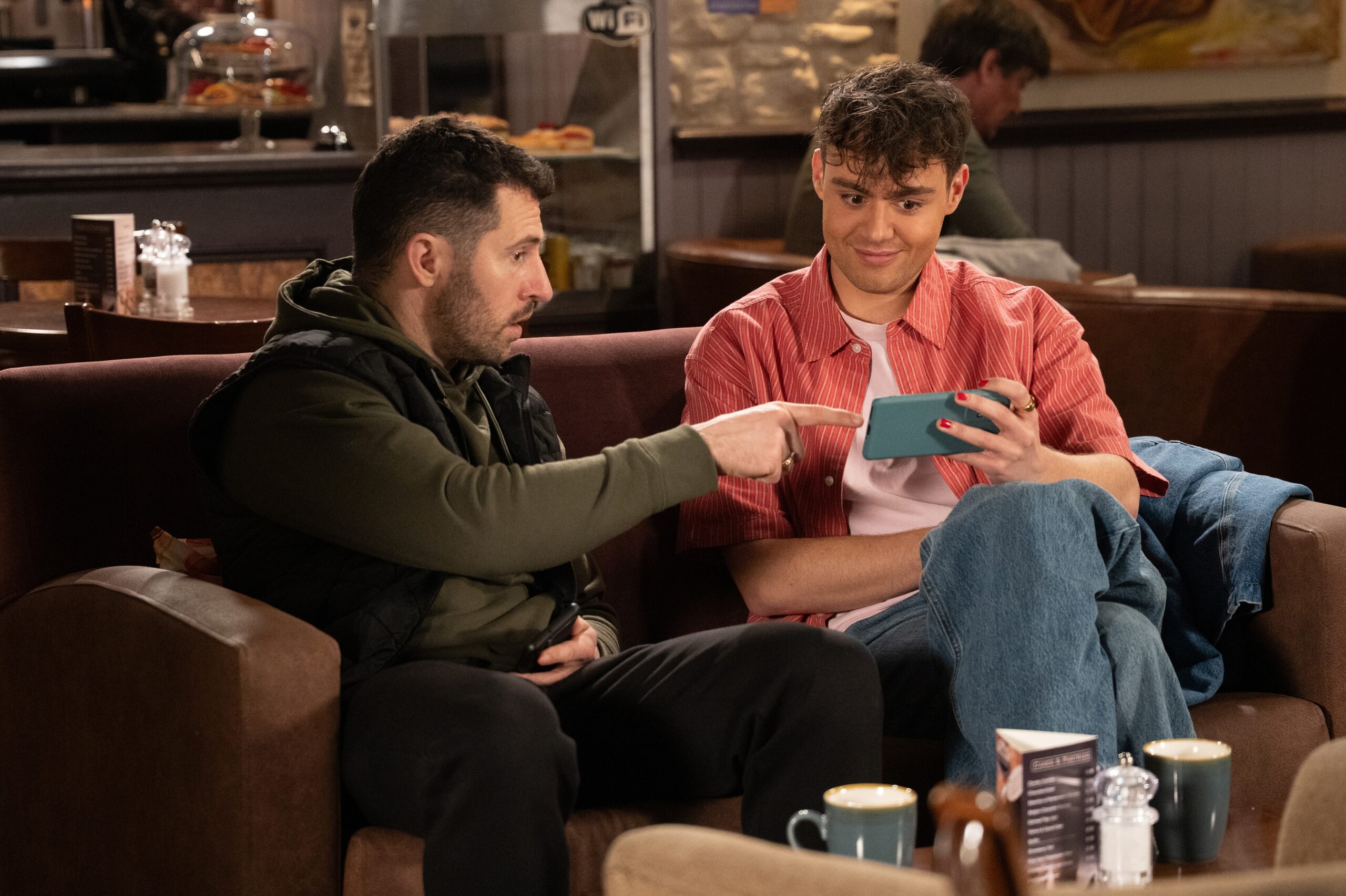 Ross and Lewis looking at a phone