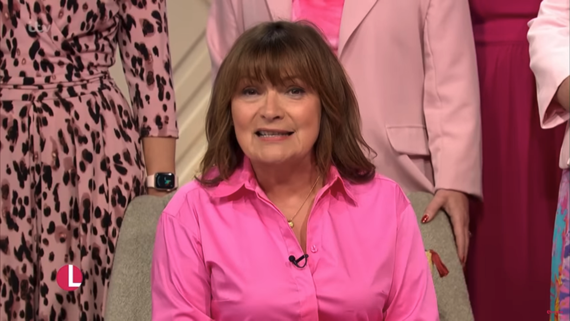 Lorraine Kelly presenting her show in a pink dress