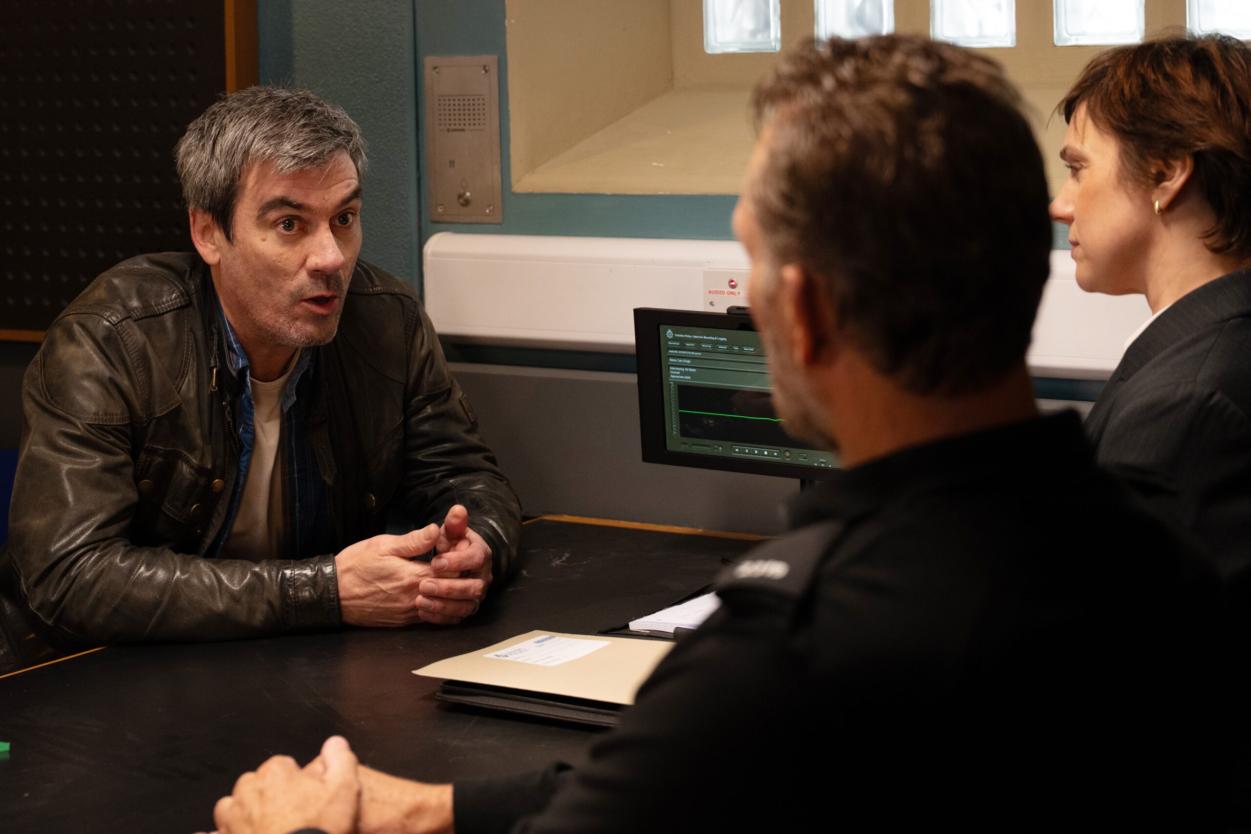 Cain at the police station in Emmerdale