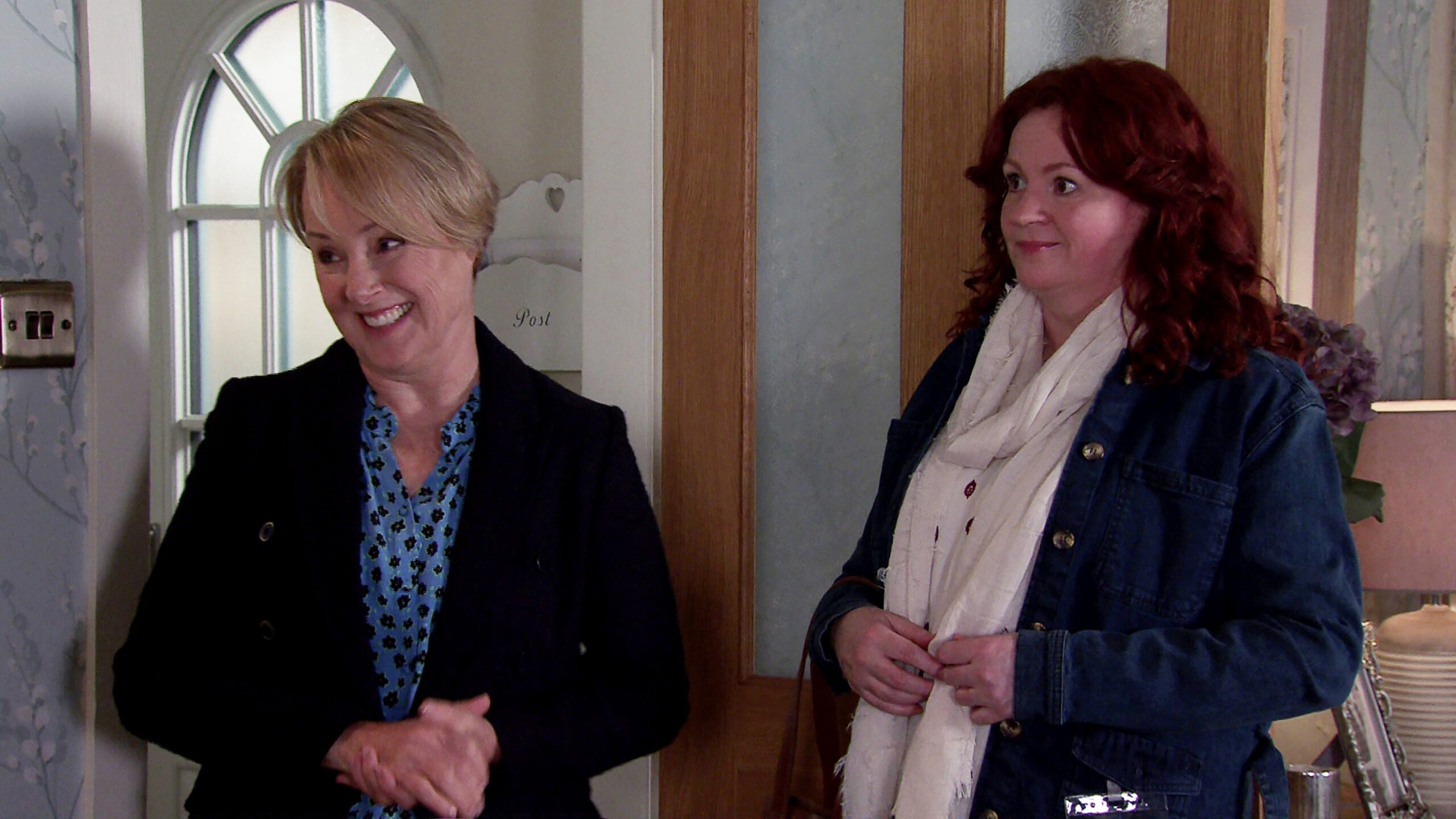 Coronation Street's Sally smiles next to a social worker