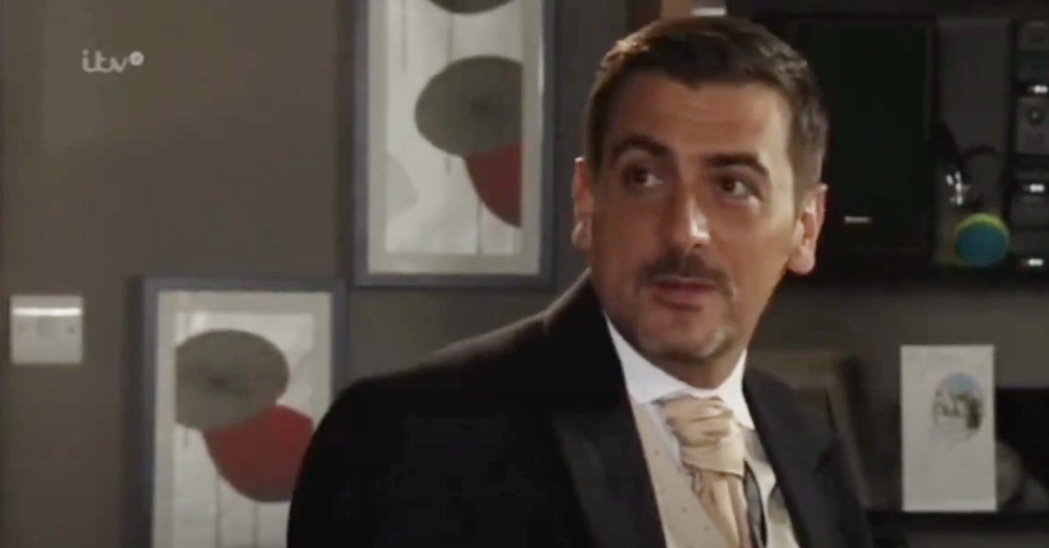 Peter smiling in his wedding suit on Coronation Street