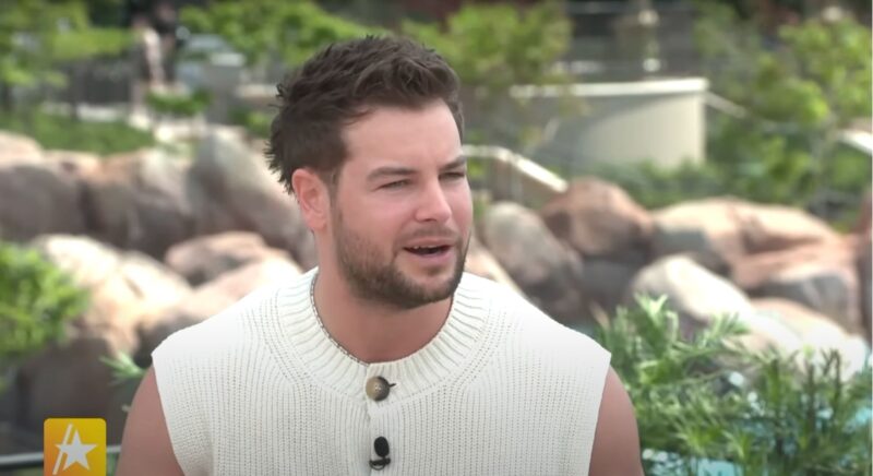 Chris Hughes in a vest in an interview
