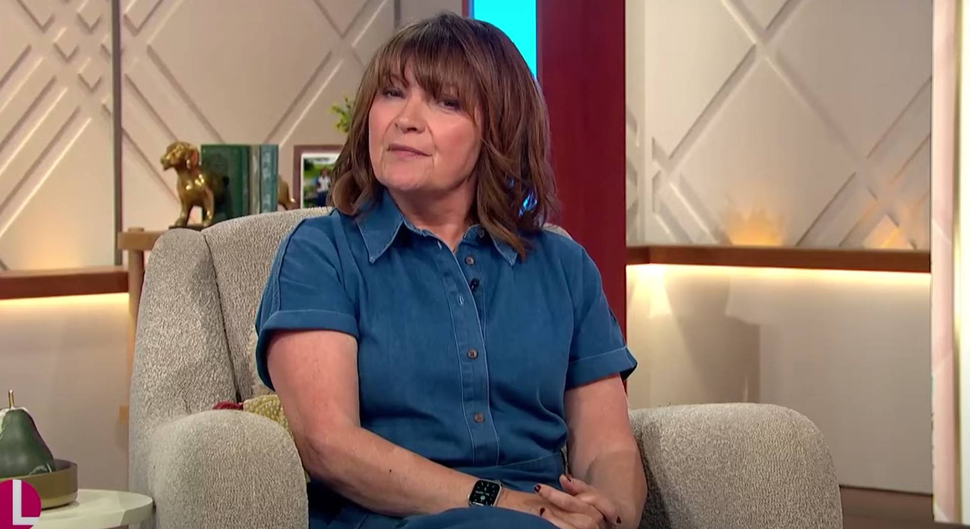 Lorraine Kelly sits with her hands in her lap