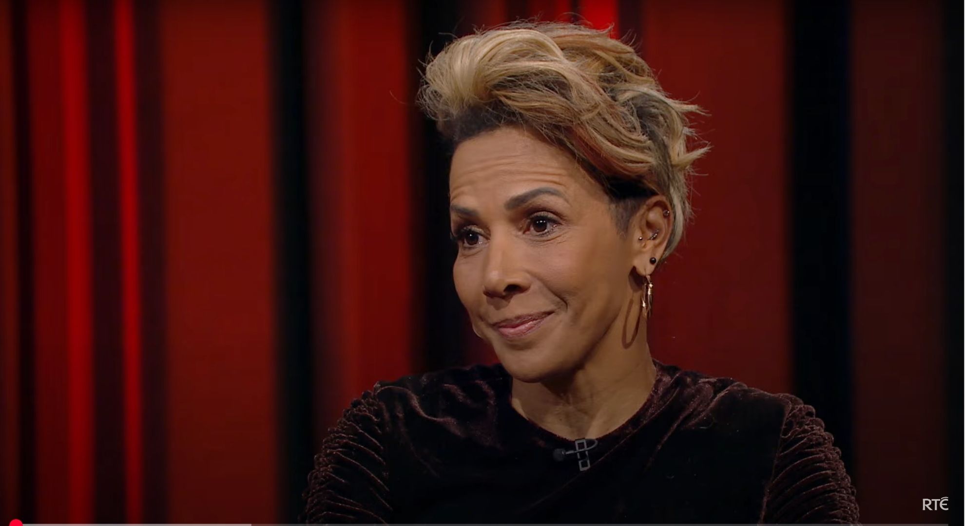 Dame Kelly Holmes smiling in an interview