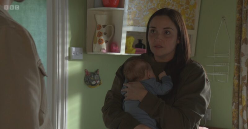 Lauren looks worried as she holds Jimmy on EastEnders