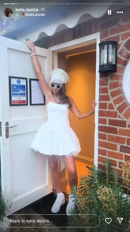 Katie Dadzie in a short white dress