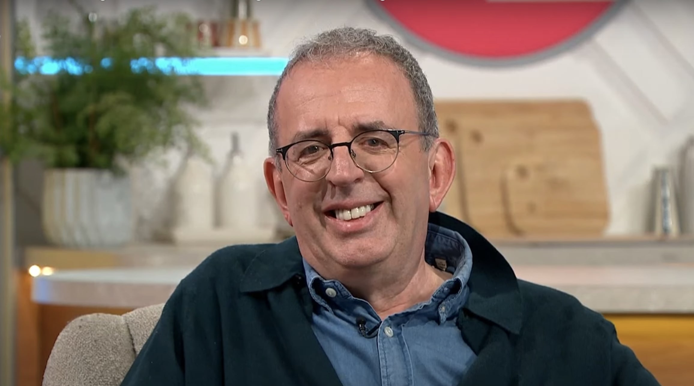 Richard Coles in a blue shirt and navy overshirt discussing weight loss on Lorraine