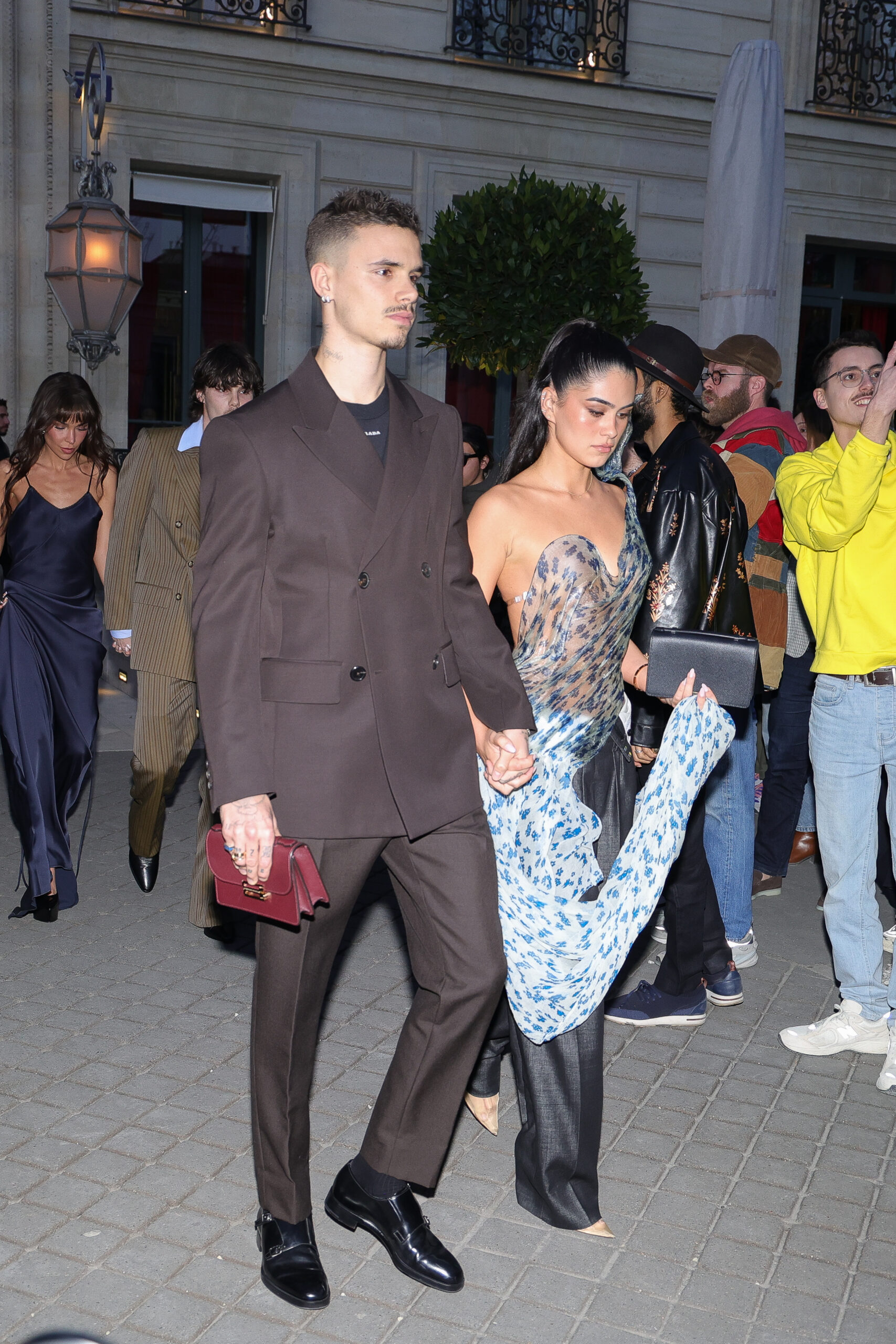 Romeo Beckham and Kim Turnbull walking hand in hand